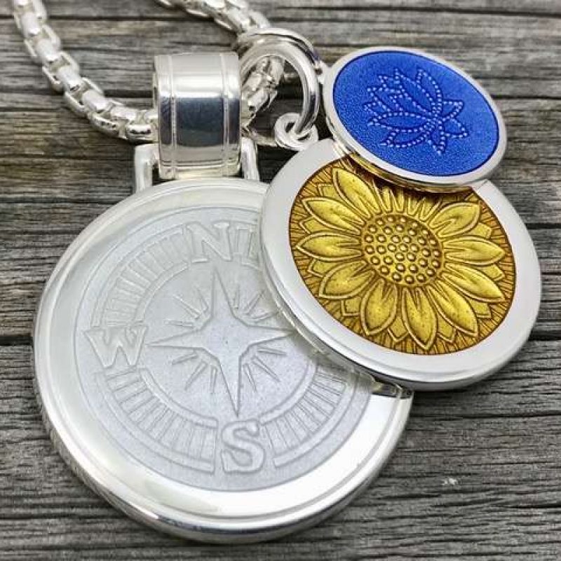 Silver necklace pendants with gold and blue flowers